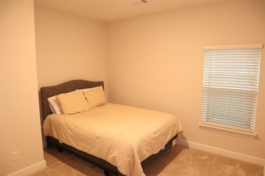 Bedroom featuring carpet and baseboards Bedroom featuring carpet and baseboards
