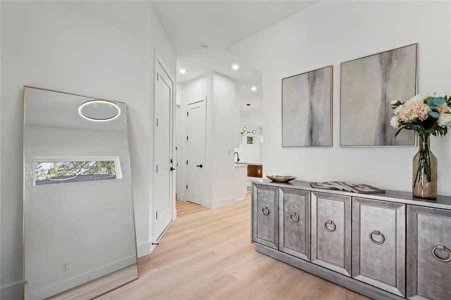 Corridor featuring light wood-style floors and recessed lighting