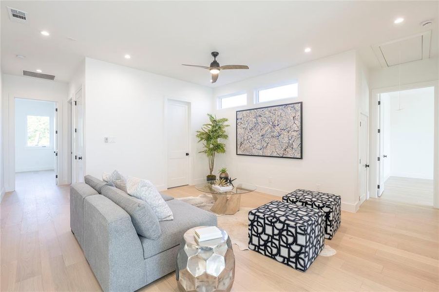 Living room with light wood-type flooring and ceiling fan