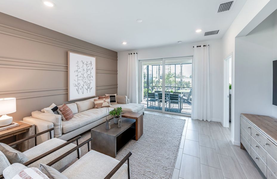Open gathering room with sliding glass doors to the covered lanai