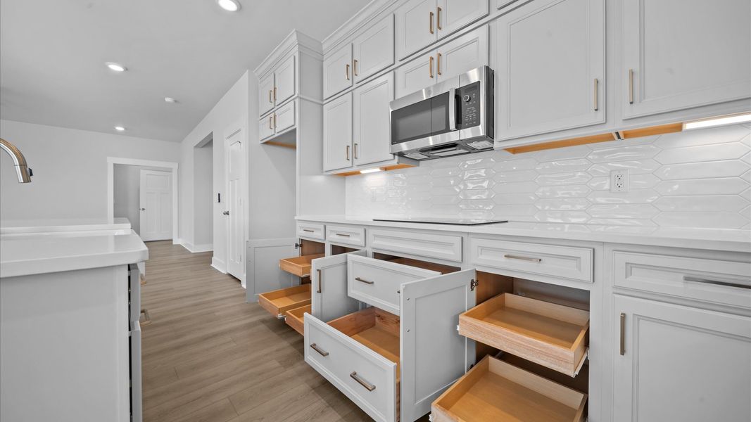 Tasteful design meets functional luxury in this gourmet kitchen with a 8-foot island and modern pendant lighting