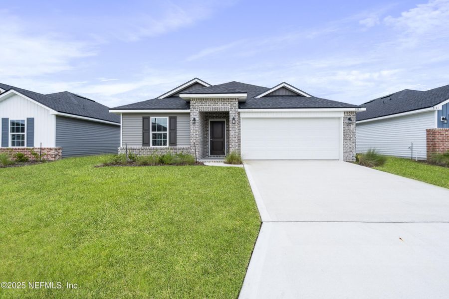 Front exterior of a new home in Summerglen, Jacksonville, FL, highlighting curb appeal (Image 1). Front exterior of a new home in Summerglen, Jacksonville, FL, highlighting curb appeal (Image 1).