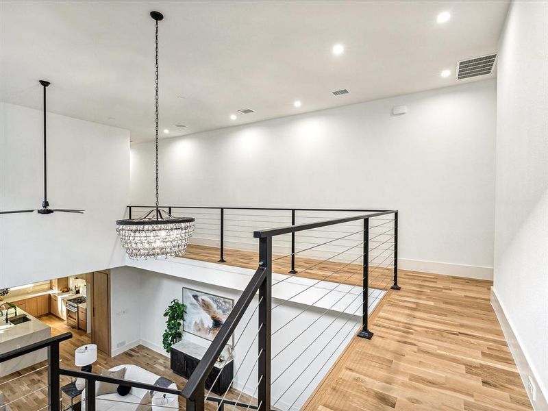 Hall featuring a notable chandelier and light wood-type flooring