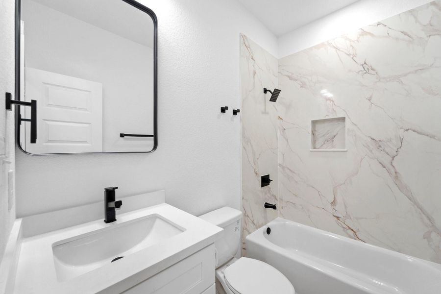 Secondary bedroom with shower/tub combo, and granite countertops.