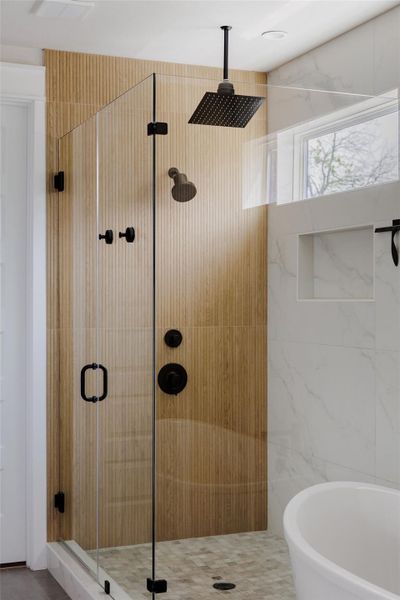 Full bathroom with a stall shower and a freestanding bath