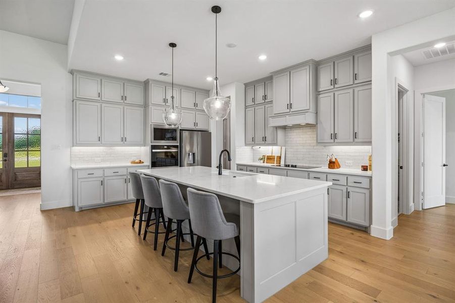 This kitchen is a showstopper with so much cabinet space & quartz counters.