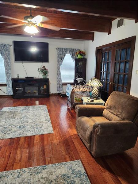 Another view of living room showing double wooden doors leading to primary bed room. Another view of living room showing double wooden doors leading to primary bed room.