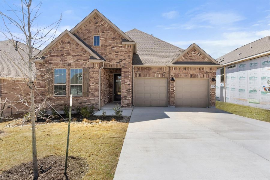 Front exterior of a new home in The Trails at Carmel, Pflugerville, TX, highlighting curb appeal (Image 23).