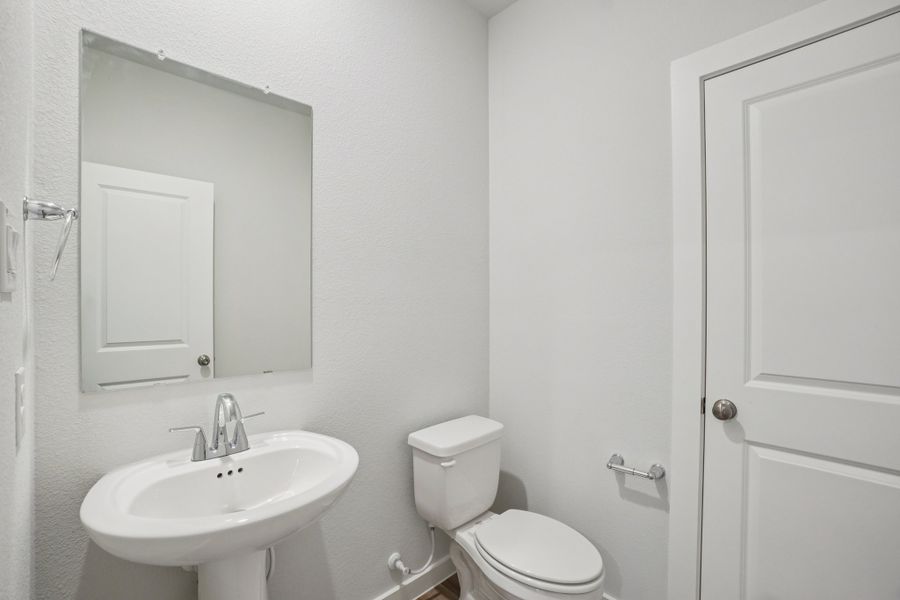 A bathroom with a toilet and sink.