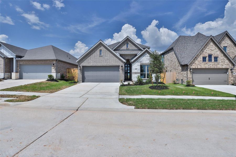 Front exterior of a new home in Escondido, Magnolia, TX, highlighting curb appeal (Image 2).