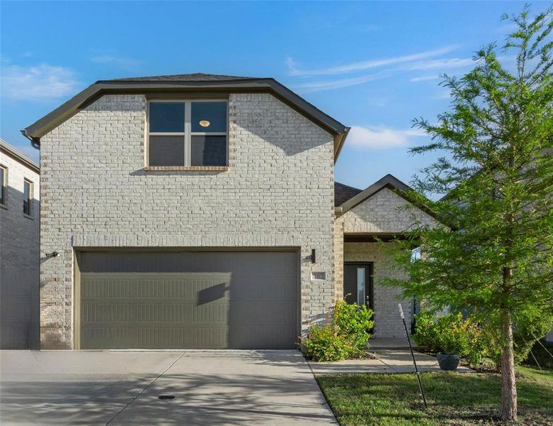 View of front of home featuring driveway, brick siding, and an attached garage View of front of home featuring driveway, brick siding, and an attached garage