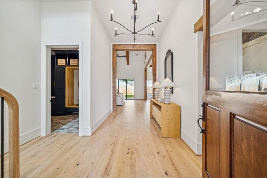 The front door is 9 ft tall and opens to a wide foyer with an elegant chandelier. The mudroom and garage doors are on the left. The front door is 9 ft tall and opens to a wide foyer with an elegant chandelier. The mudroom and garage doors are on the left.