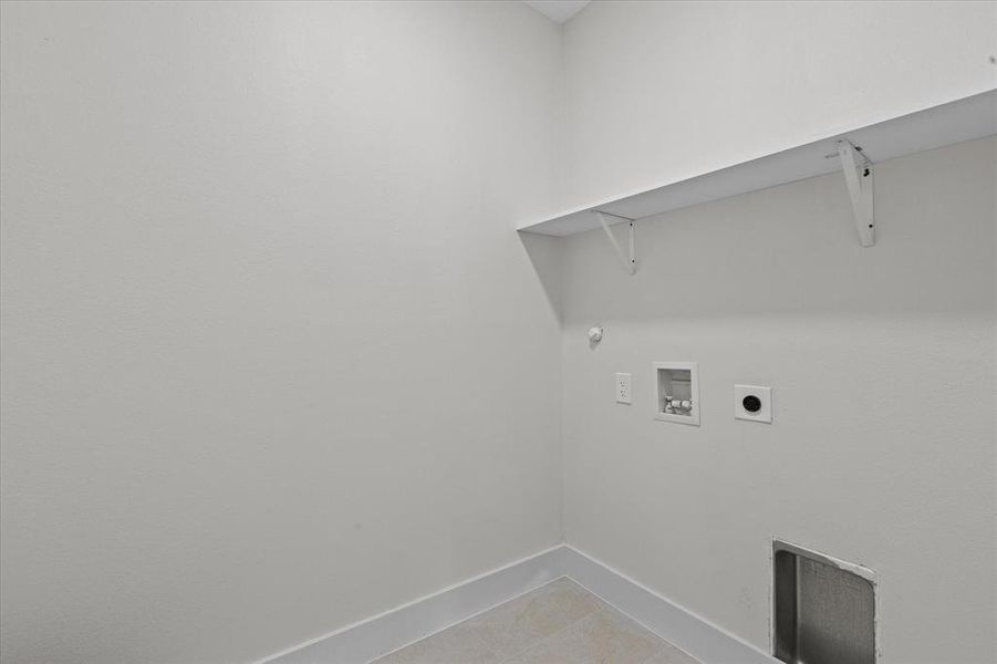 Washroom featuring washer hookup, light tile patterned floors, hookup for an electric dryer, and gas dryer hookup