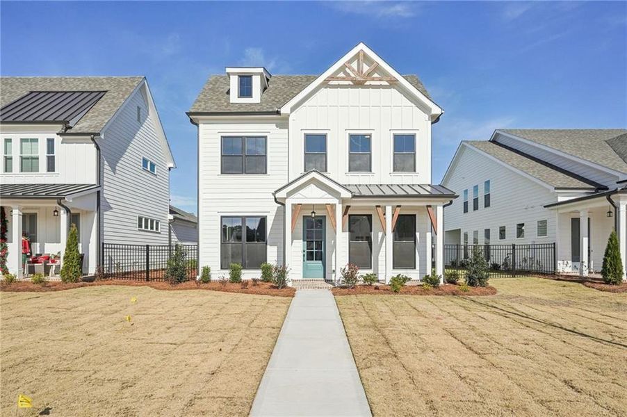 Front exterior of a new home in Promenade at Sawnee Village, Cumming, GA, highlighting curb appeal (Image 27). Front exterior of a new home in Promenade at Sawnee Village, Cumming, GA, highlighting curb appeal (Image 27).
