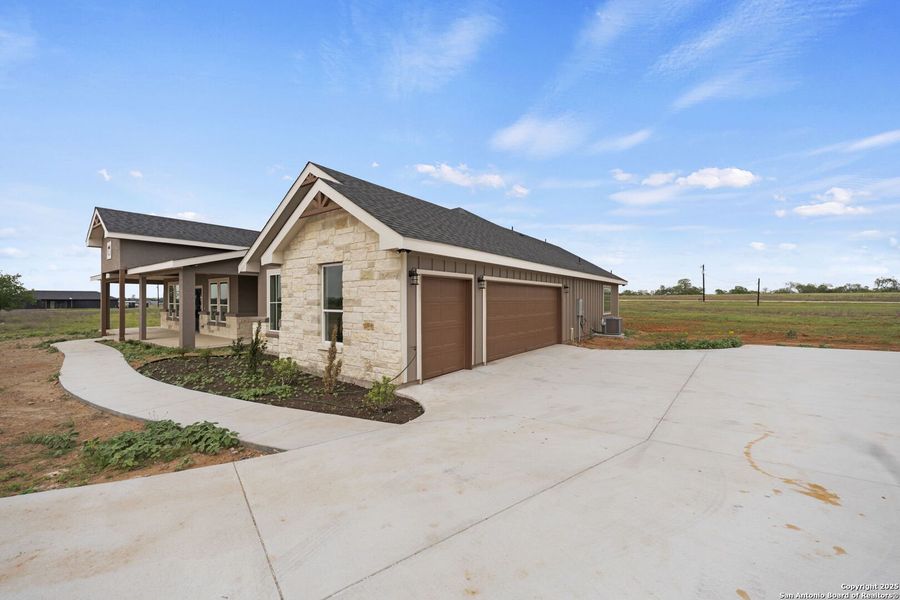 Front exterior of a new home in , Floresville, TX, highlighting curb appeal (Image 23).