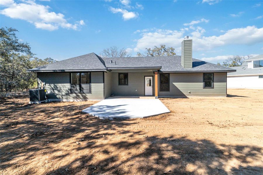 Back of home with covered patio and extended patio