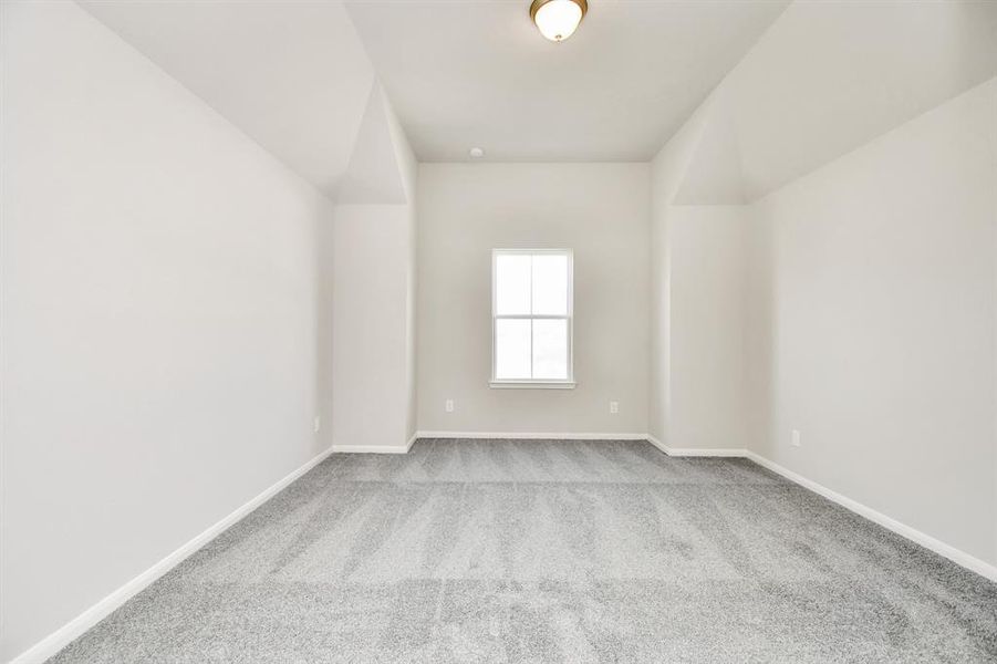 Third bedroom features plush carpet and large window.