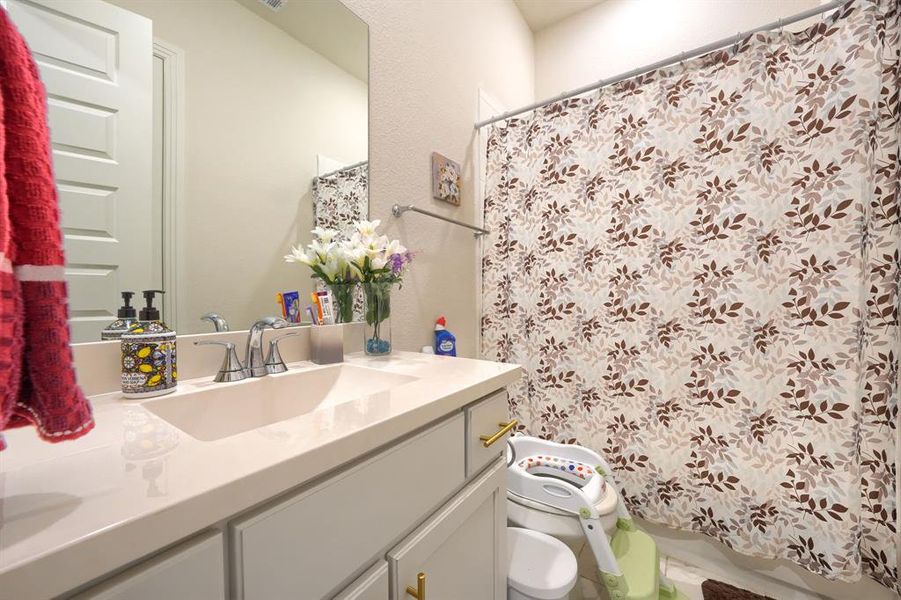 Bathroom with vanity, toilet, and a bidet