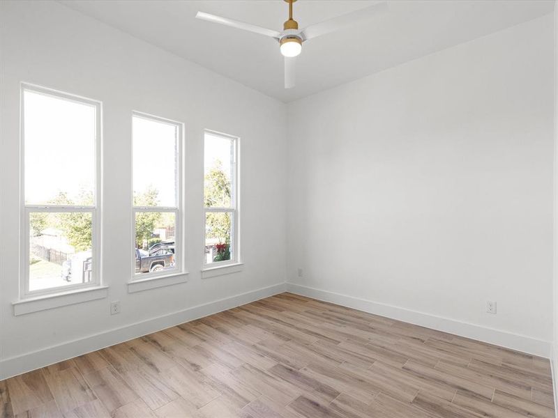 Unfurnished room with baseboards and light wood-type flooring