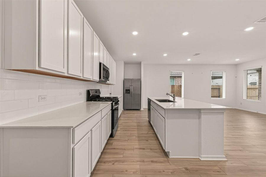 Stylish open kitchen with a large island, abundant cabinetry, and a layout that keeps everyone connected whether cooking, entertaining, or gathering with family and friends