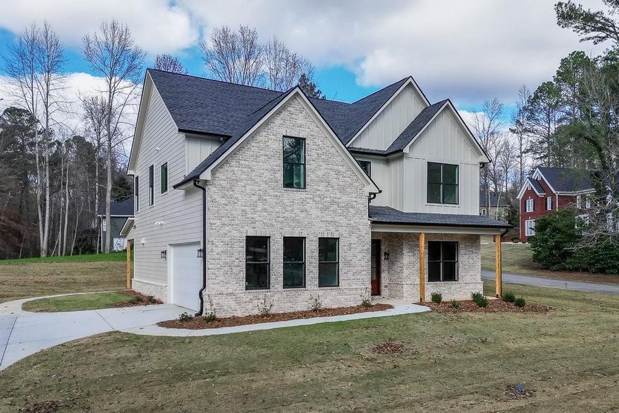 Front exterior of a new home in , Flowery Branch, GA, highlighting curb appeal (Image 25).