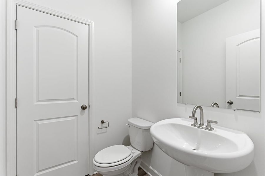 A bathroom with a toilet and sink.
