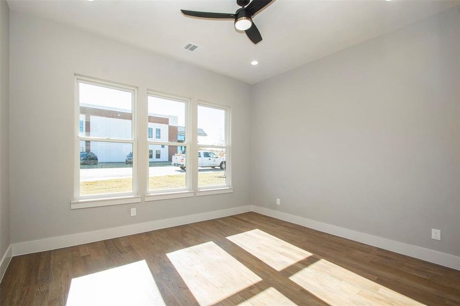 Spare room with ceiling fan and hardwood / wood-style flooring