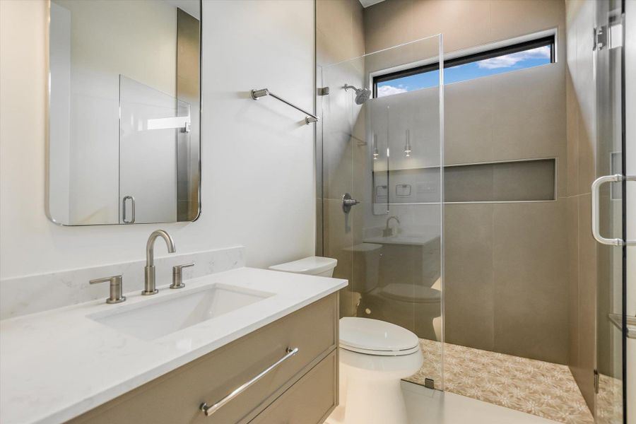 Contemporary bathroom with a single vanity, undermount sink, and brushed nickel fixtures