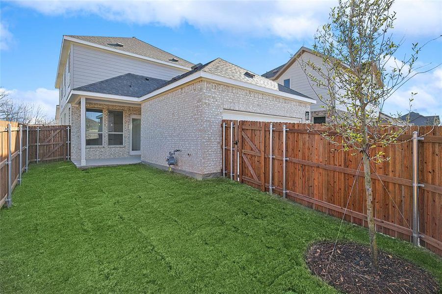 Rear view of property featuring a lawn