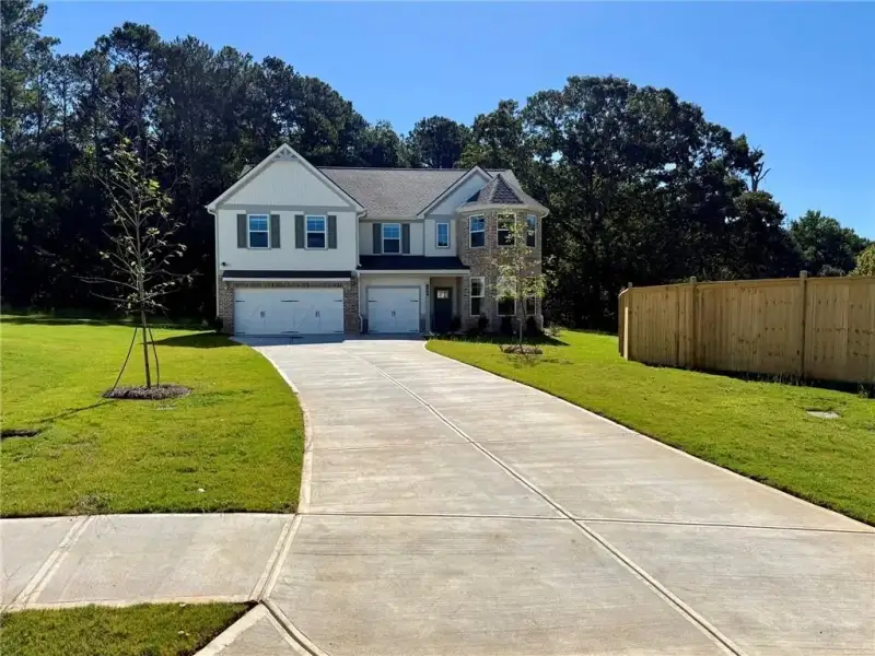Front exterior of a new home in Grandview at Millers Mill, Stockbridge, GA, highlighting curb appeal (Image 18).