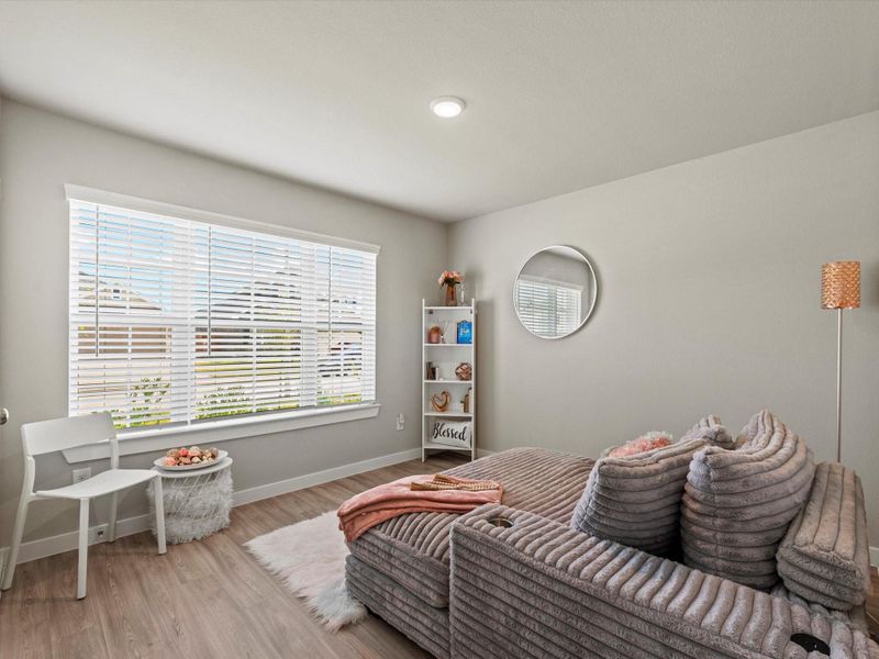 Front bedroom / flex room with large window, perfect for a bedroom, playroom, or study.