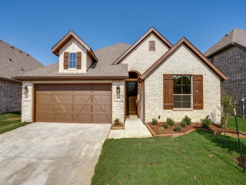 Example of same Thackery Custom Home floorplan Craftsman-style home featuring a light brick facade, dark wood trim, and a two-car garage Example of same Thackery Custom Home floorplan Craftsman-style home featuring a light brick facade, dark wood trim, and a two-car garage