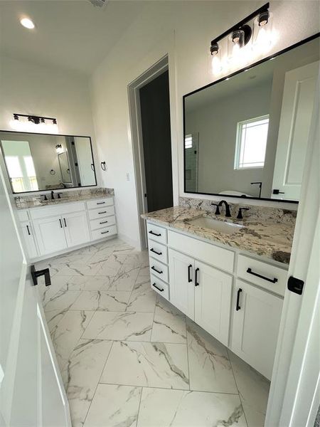 Bathroom with marble look tiles and two vanities Bathroom with marble look tiles and two vanities