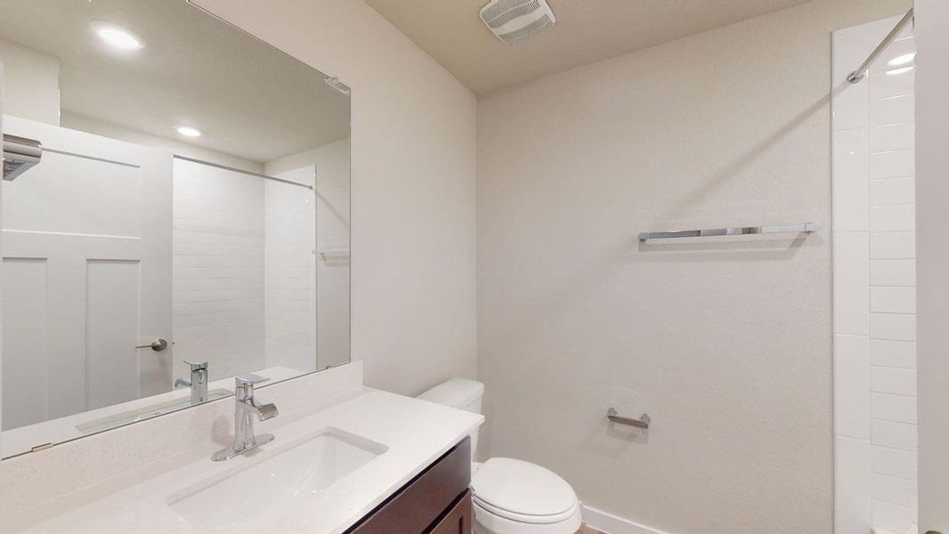 A well-lit, contemporary bathroom boasts a vanity with ample counter space and sleek fixtures. A well-lit, contemporary bathroom boasts a vanity with ample counter space and sleek fixtures.