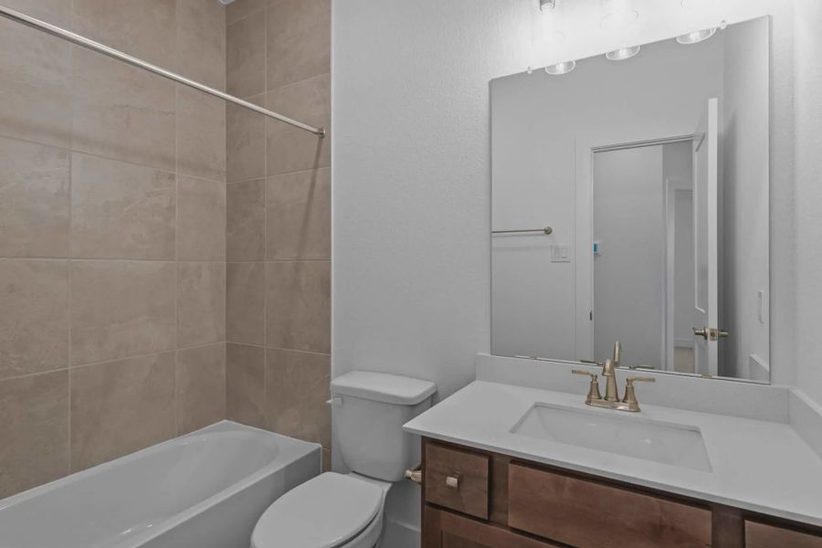 Representative furnished interior of a home built from the Carriagehouse by Chesmar Homes in Meridiana Townhomes, Iowa Colony (Image 18).