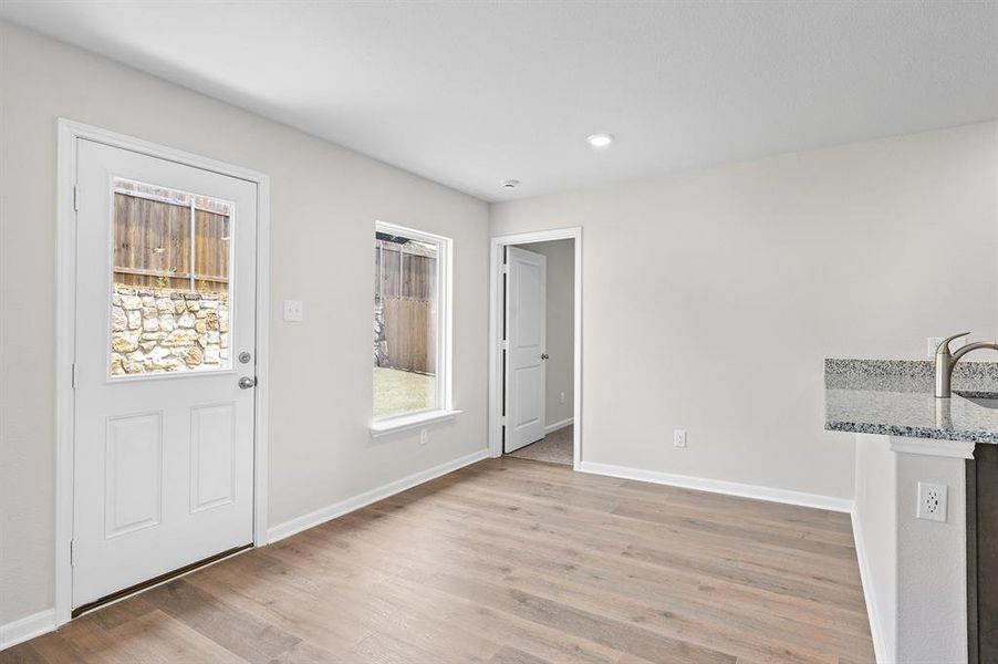 Foyer with light wood-style floors and recessed lighting