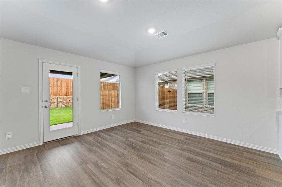 Spare room with wood finished floors and lofted ceiling Spare room with wood finished floors and lofted ceiling