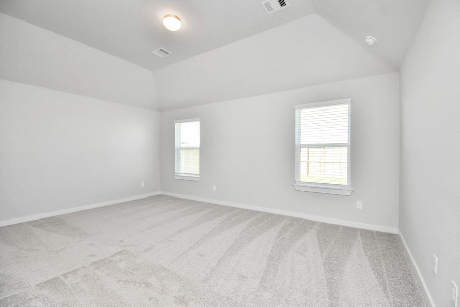 Escape to tranquility in this spacious primary room, adorned with plush carpeting and bathed in the soothing hues of warm paint colors, creating a cozy retreat for relaxation. Sample photo of completed home with similar floor plan. Actual colors and selections may vary. Escape to tranquility in this spacious primary room, adorned with plush carpeting and bathed in the soothing hues of warm paint colors, creating a cozy retreat for relaxation. Sample photo of completed home with similar floor plan. Actual colors and selections may vary.