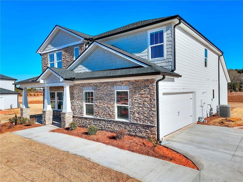 Front exterior of a new home in River Pointe, Monroe, GA, highlighting curb appeal (Image 29).