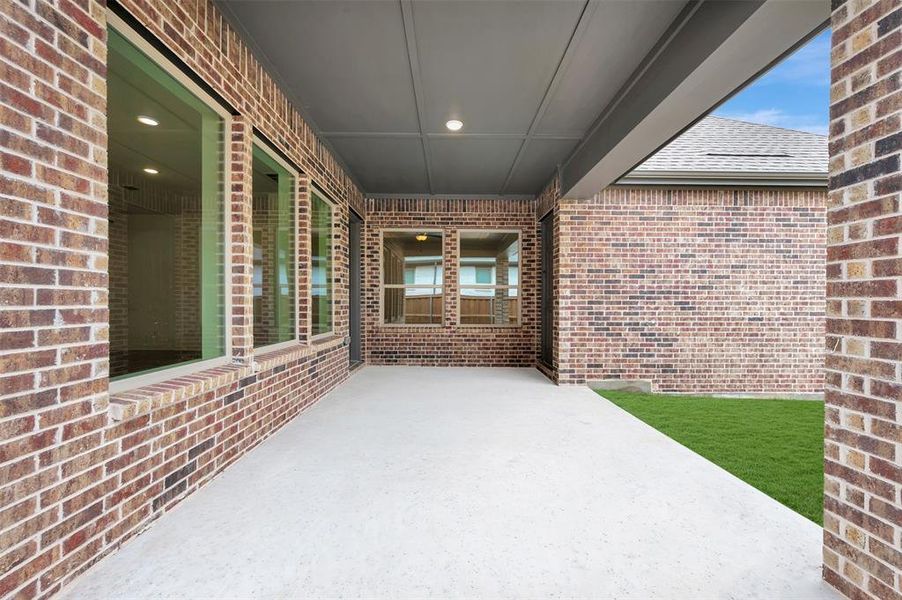This property features a covered patio with a concrete surface, providing an ideal space for outdoor enjoyment