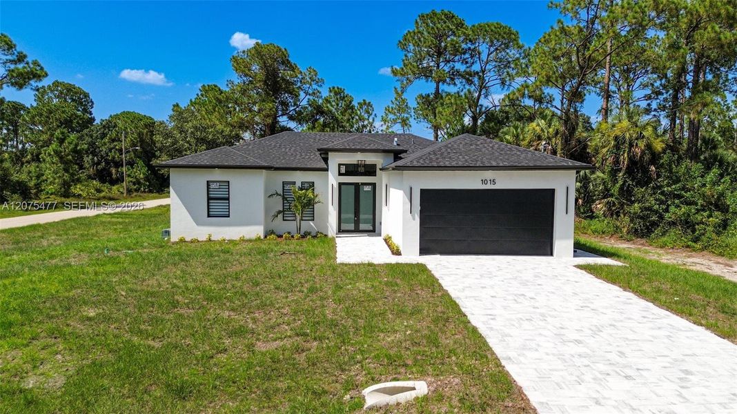 Front exterior of a new home in , Lehigh Acres, FL, highlighting curb appeal (Image 31). Front exterior of a new home in , Lehigh Acres, FL, highlighting curb appeal (Image 31).
