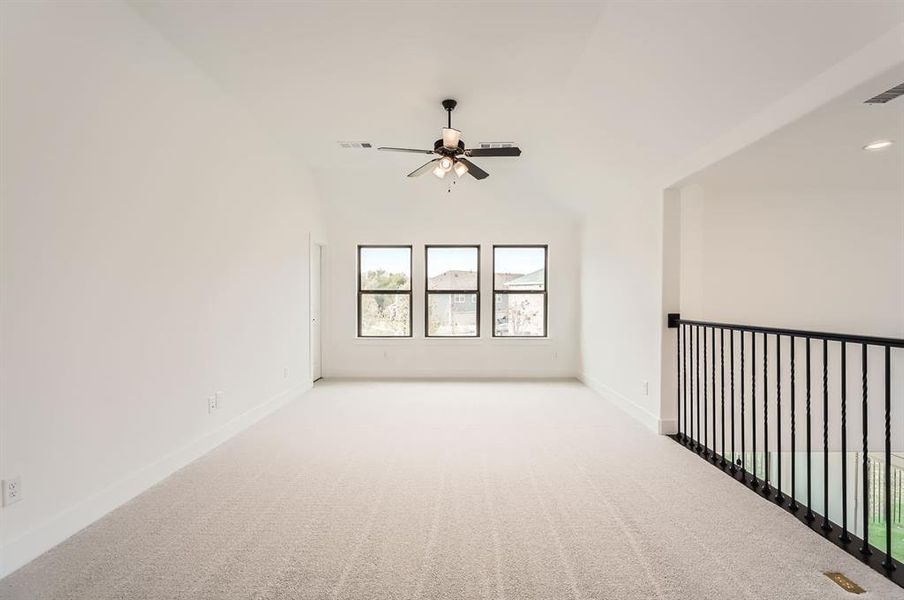 Unfurnished room featuring high vaulted ceiling, light colored carpet, and ceiling fan