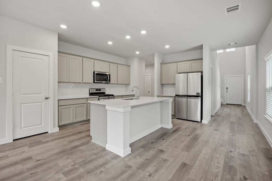 A kitchen with white cabinets.