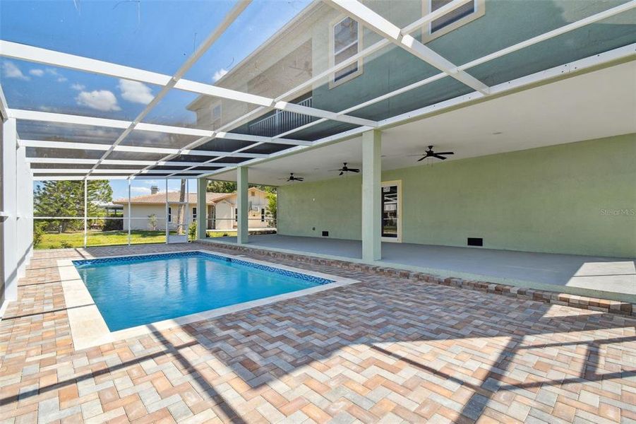 LARGE ENCLOSED IN GROUND POOL WITH PAVER DECKING