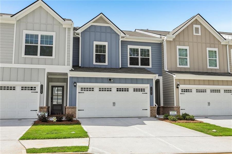 Front exterior of a new home in Ellison Square, Sugar Hill, GA, highlighting curb appeal (Image 1).
