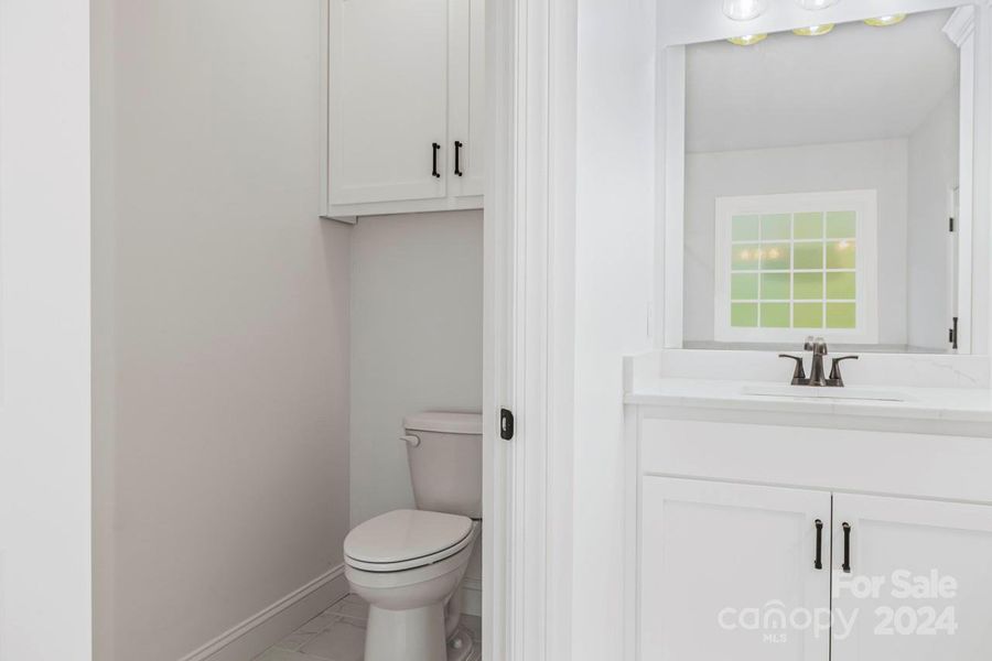 The water closet has a built in cabinet giving you more of that needed storage space