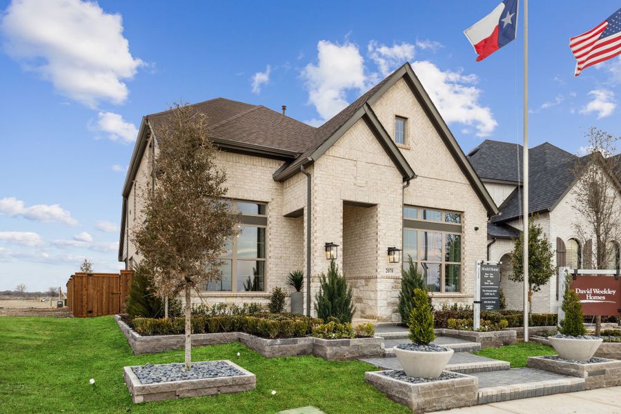 Front exterior of a new home in Mantua Point Gardens, Van Alstyne, TX, highlighting curb appeal (Image 24). Front exterior of a new home in Mantua Point Gardens, Van Alstyne, TX, highlighting curb appeal (Image 24).
