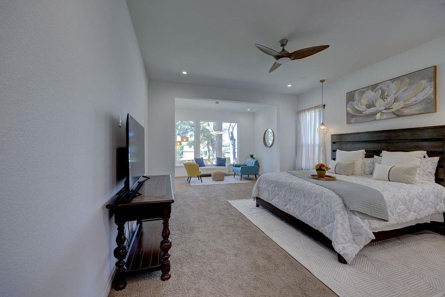 Primary Carpeted bedroom featuring ceiling fan and recessed lighting