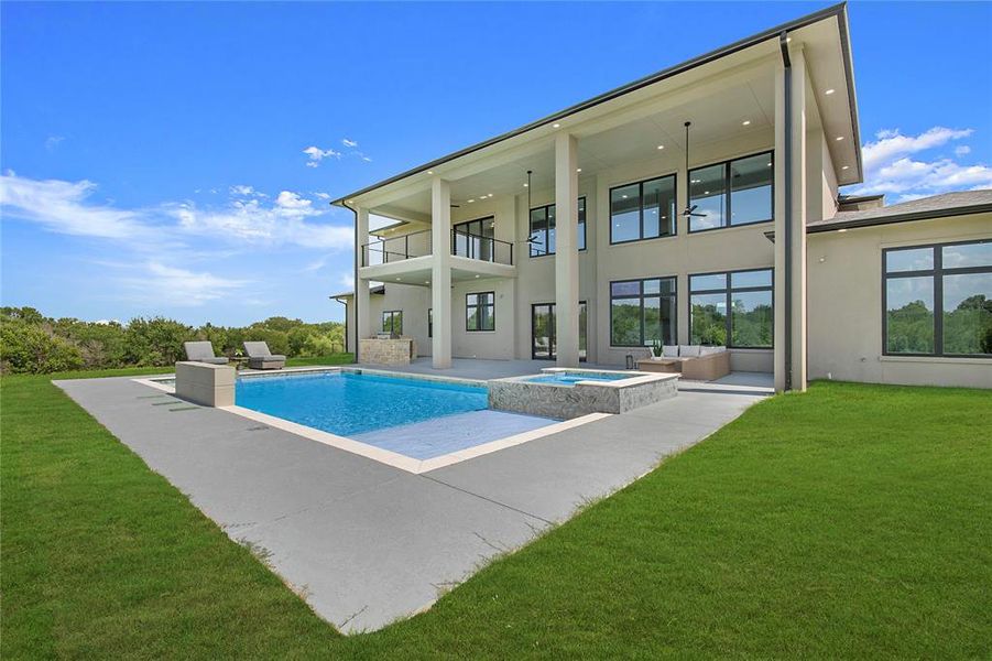 View of pool featuring a lawn, a patio, and a pool with connected hot tub