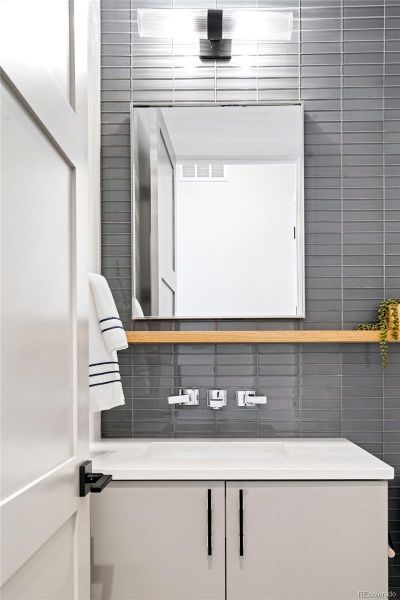 Main-floor powder room - each bath has different combinations of tile, texture and colors